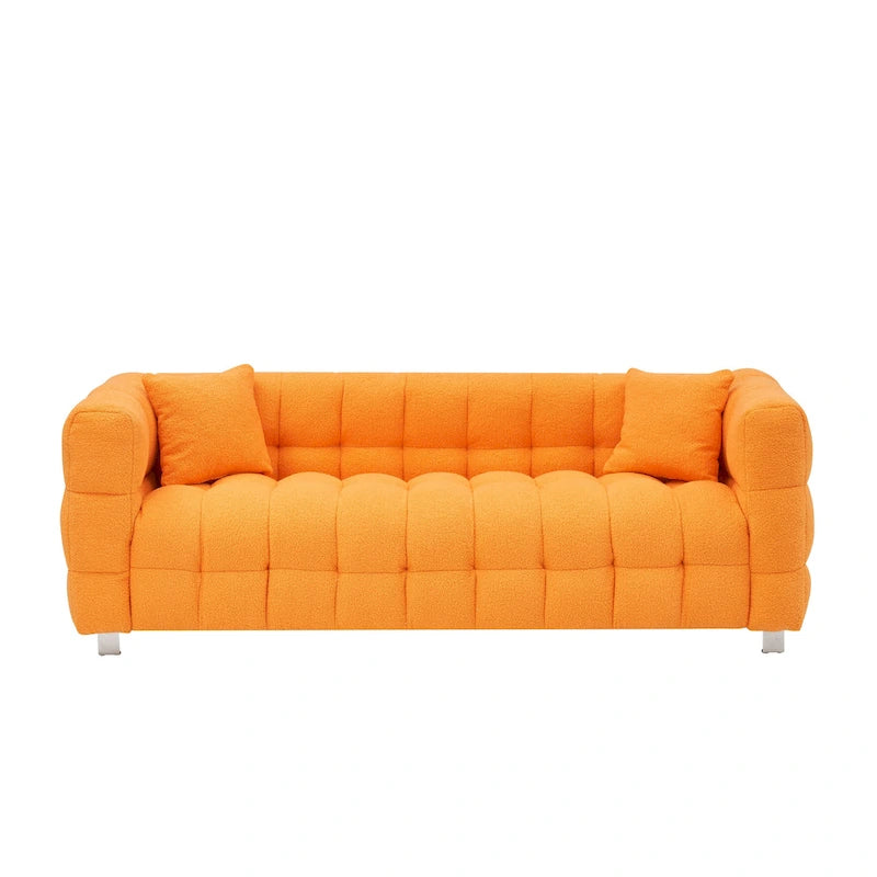 Canapé trois places orange avec deux coussins et des pieds en métal robustes